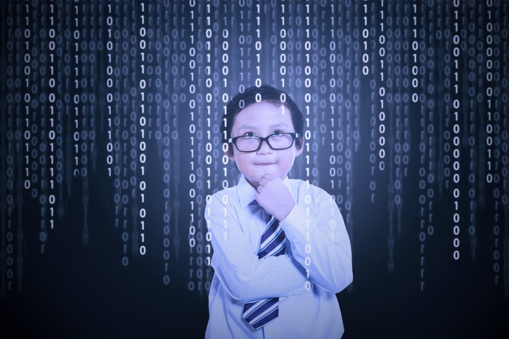 Little boy looking at binary code