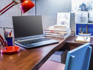 Designer modern home office desk with laptop and equipment