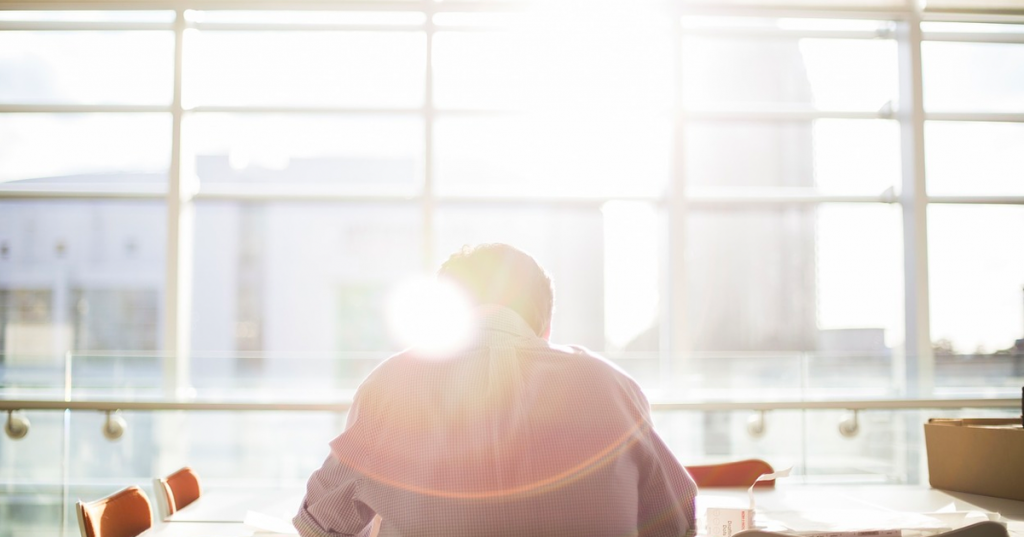 Apprentice Working At A Desk In Front Of A Sunny Window